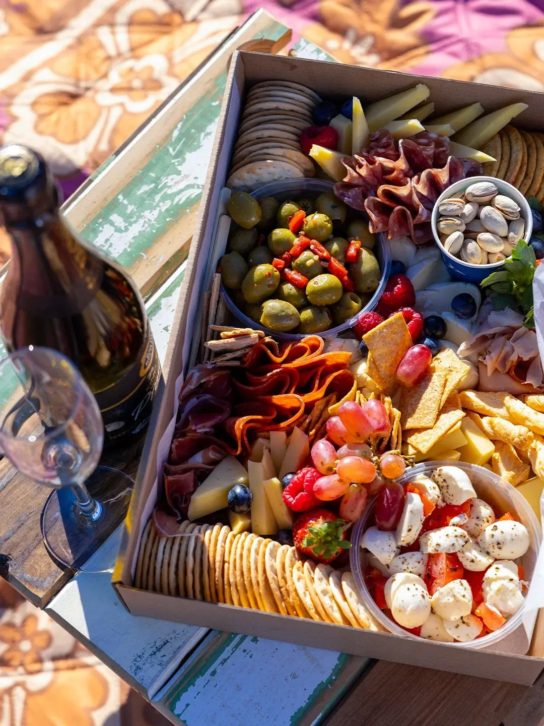A savoury picnic box of cheeses, cured meats and olives